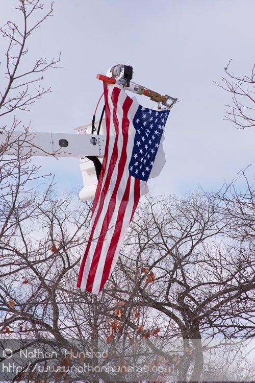 A flag hangs from a cherry picker